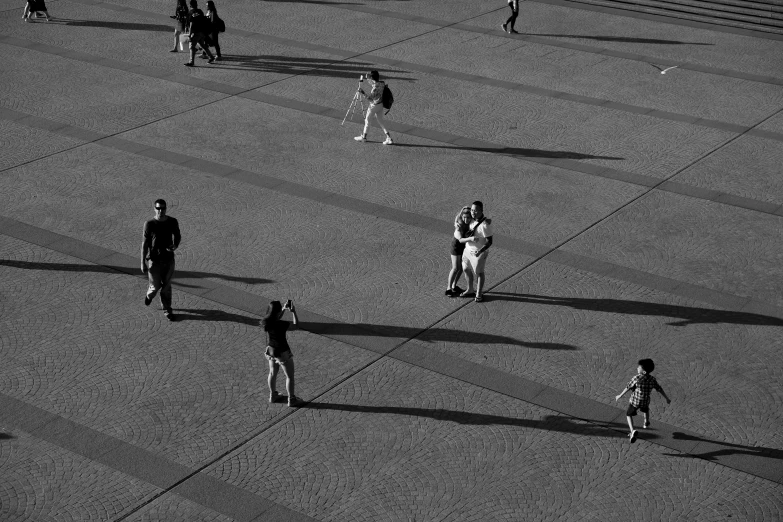 an aerial view of a man and woman's shadow and walking