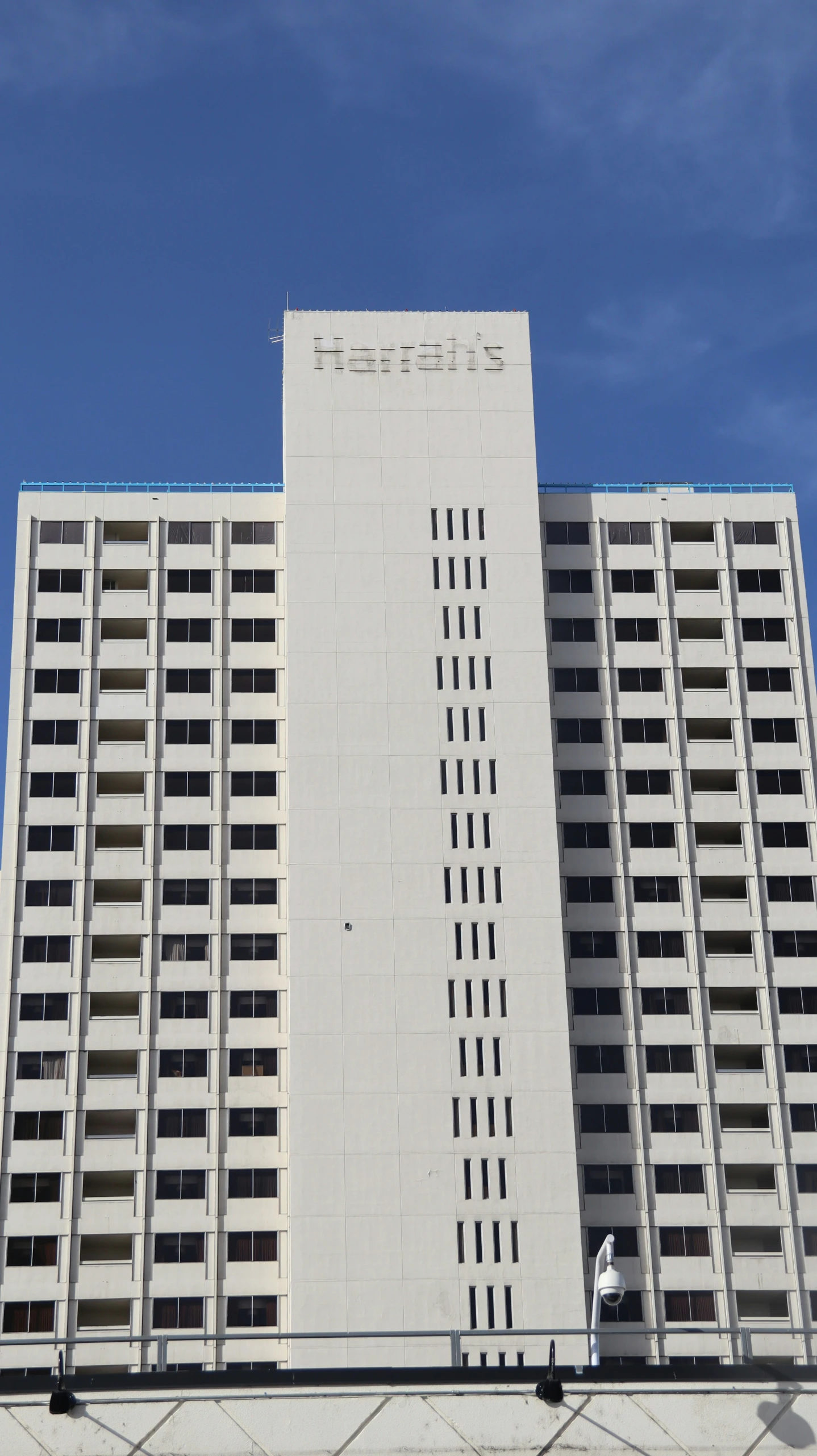 a tall building on the side of a road with balconies