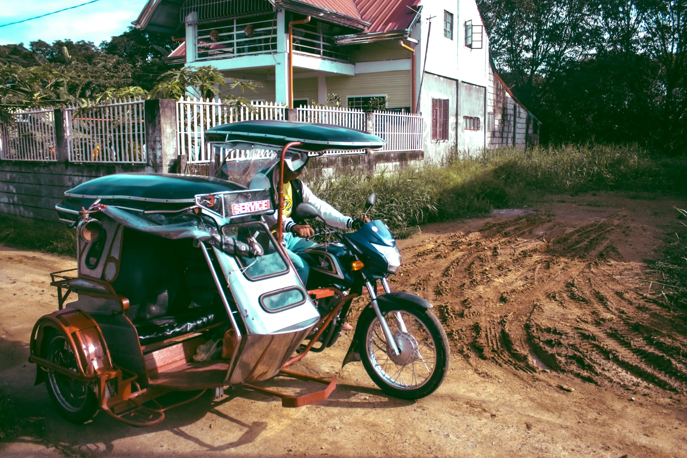 the motorcycle is carrying two seats on it's trailer