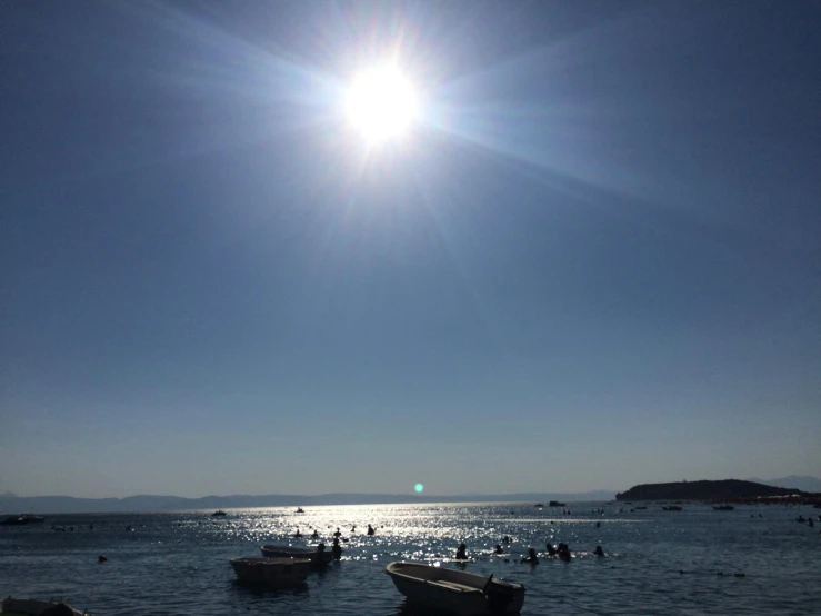 a number of boats floating in a body of water