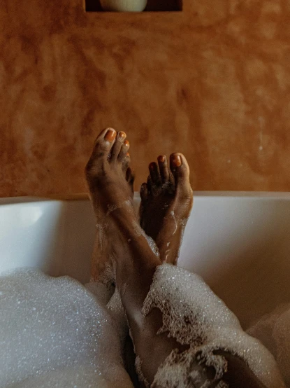 a person has their legs sticking out of a bath tub