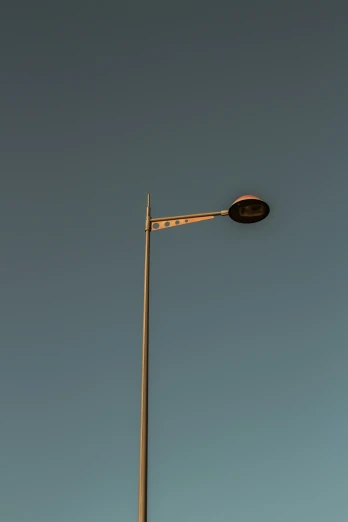 a close up of the top part of a street lamp