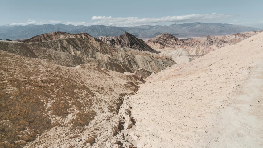 a mountain view with some rocky hills below it