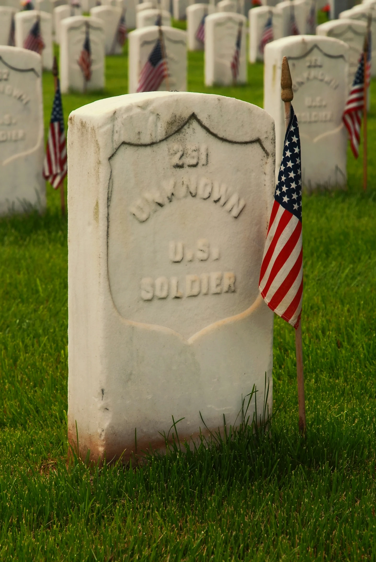a grave with a american flag sitting on it
