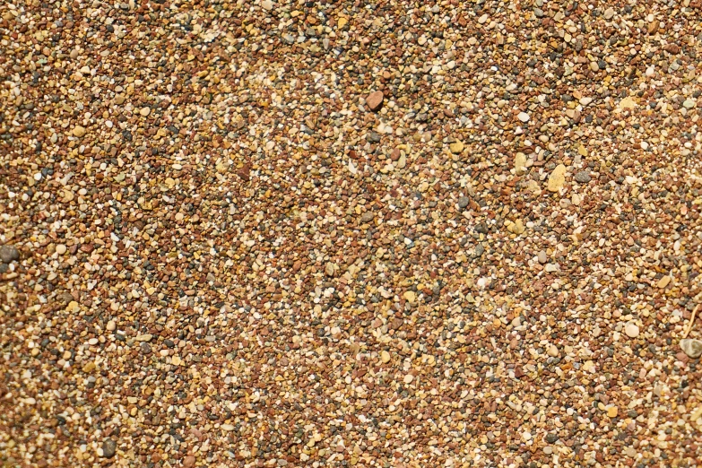 a wall covered in brown, black and white pebbles