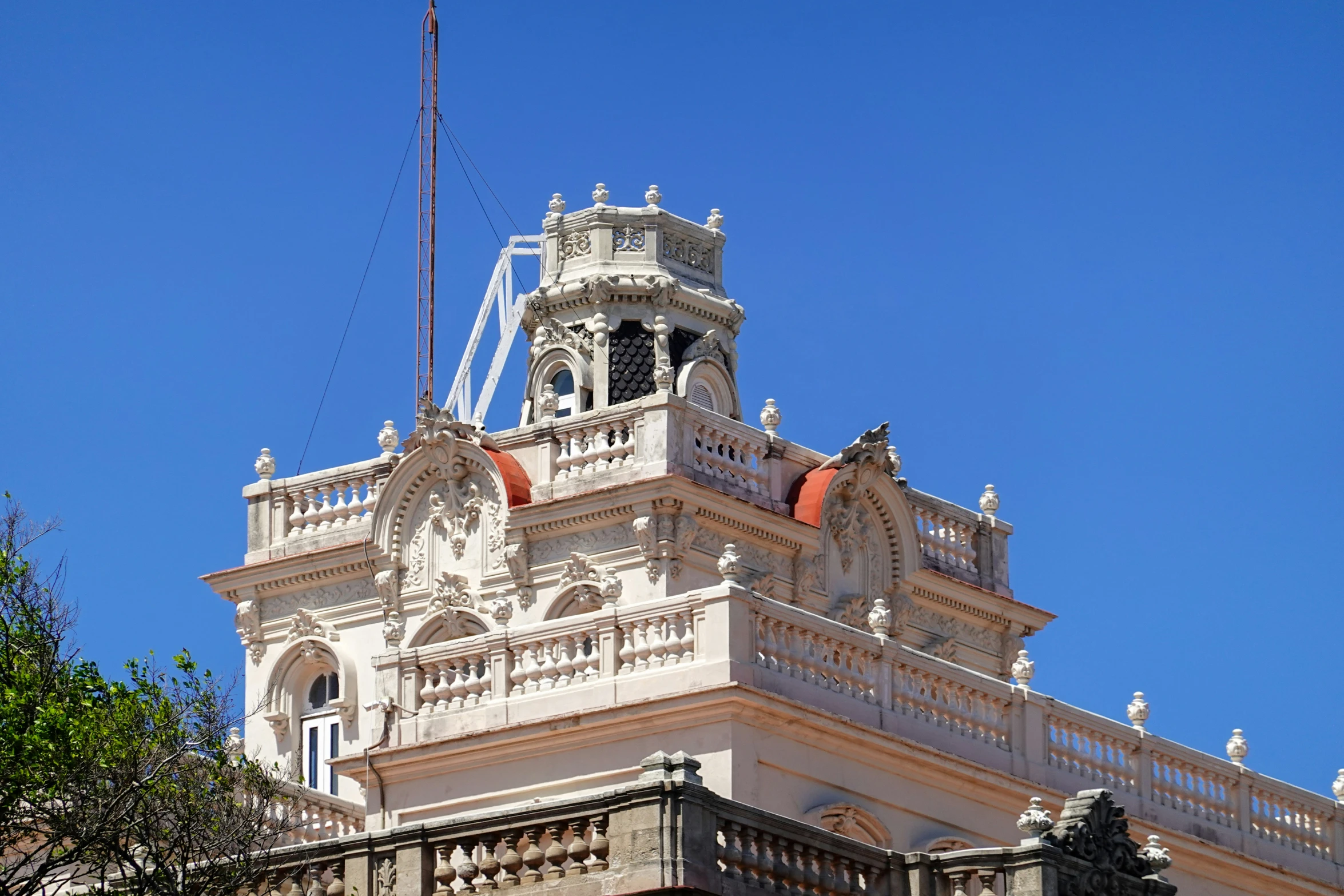 a very tall and pretty white building with some flags