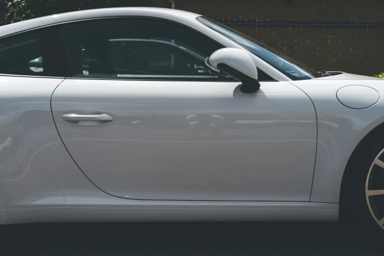 a white car with no wheels parked on a street