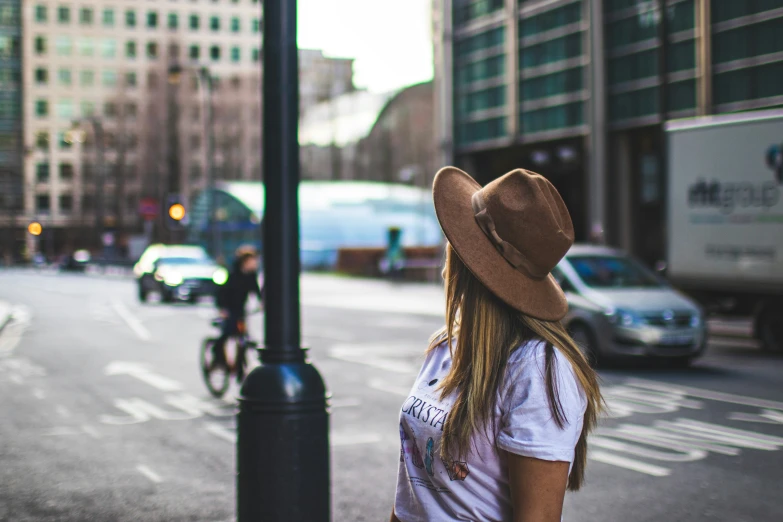 a woman looking at a city street with traffic