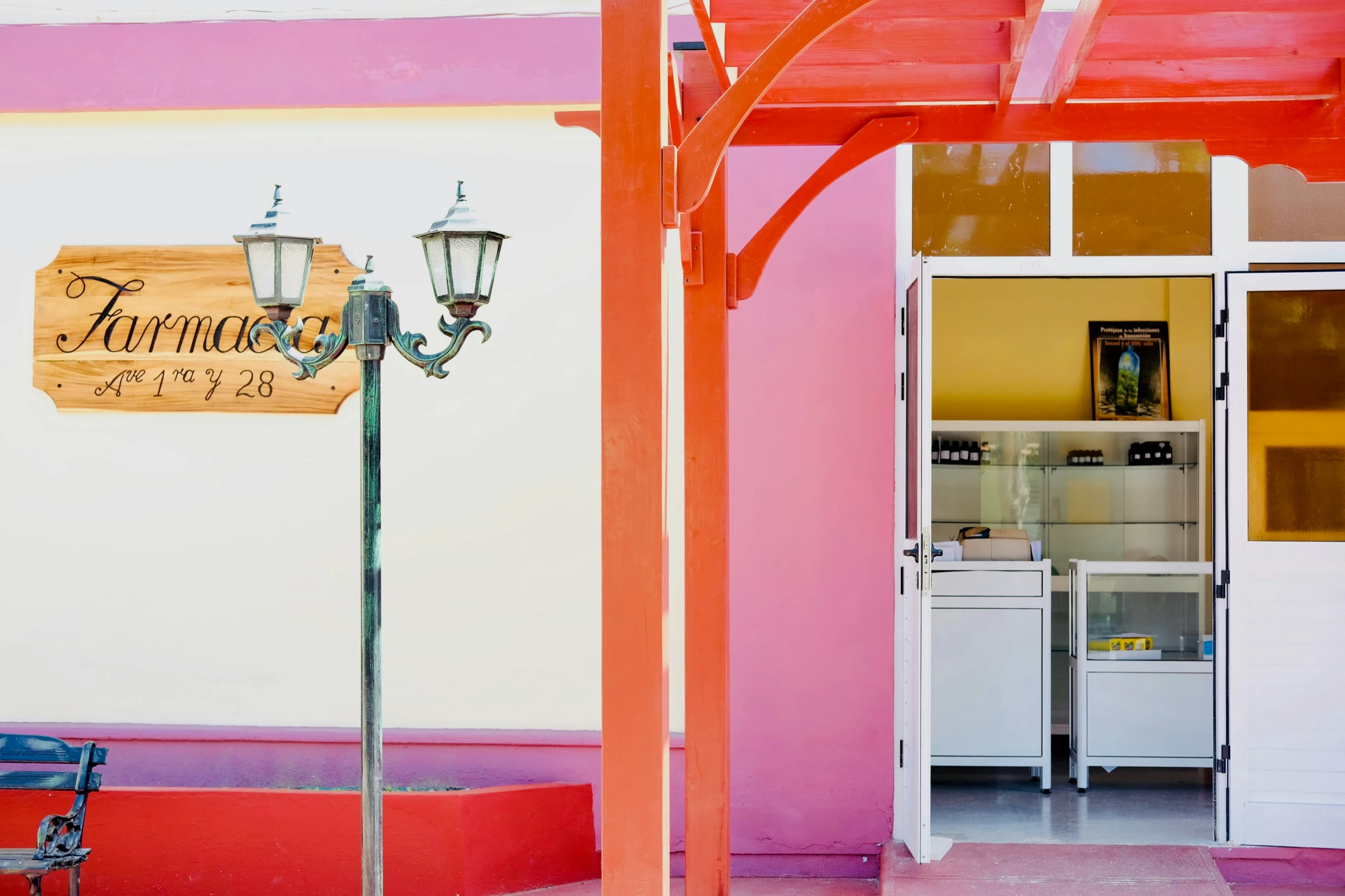 the entrance to a small restaurant with a table and a bench