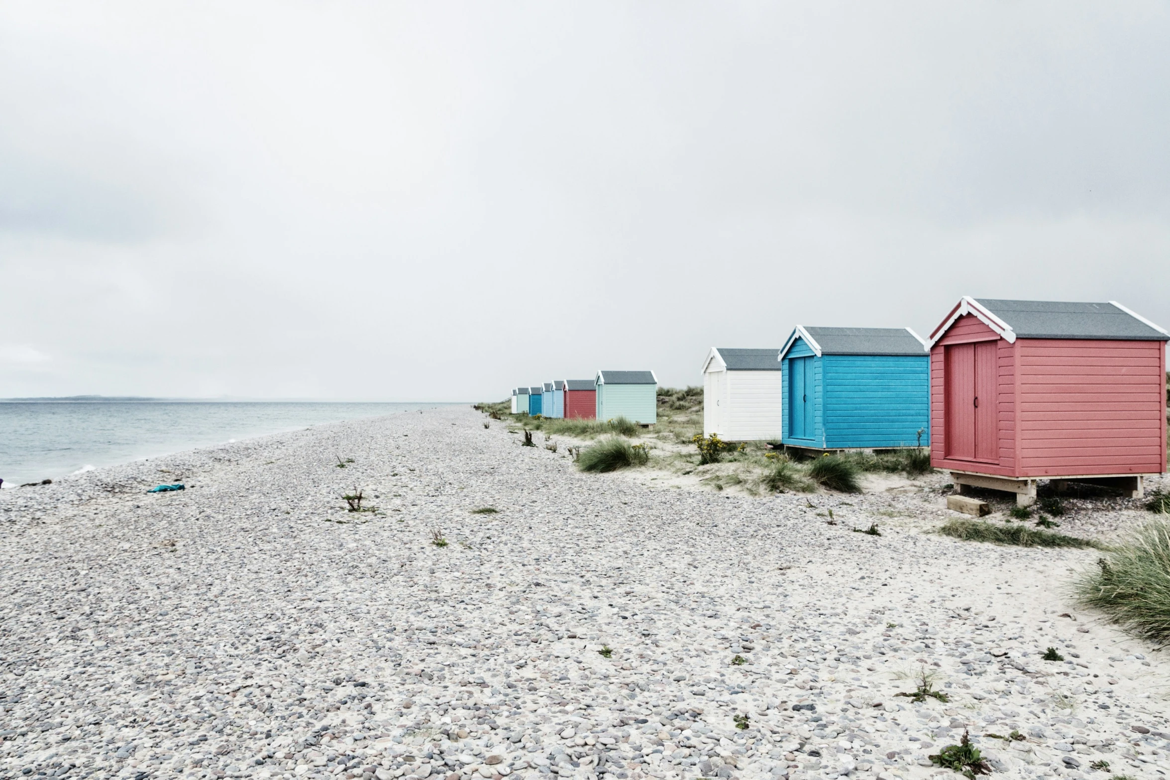 some very pretty beach huts by the water