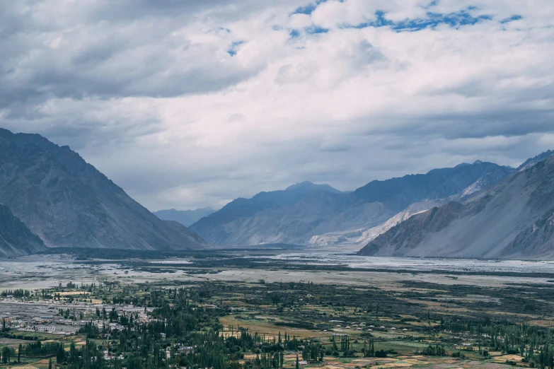 an image of a mountain range with trees in the foreground