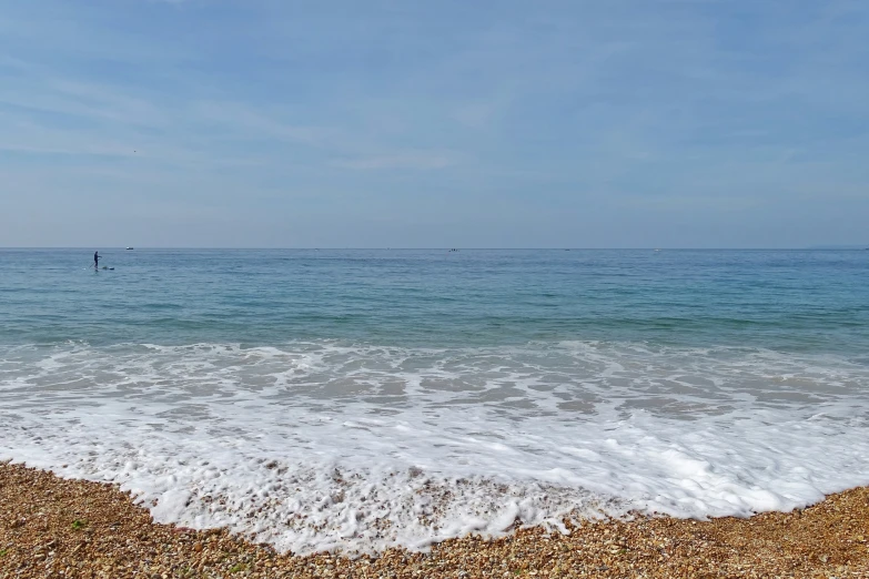 an ocean beach with waves crashing on the shore