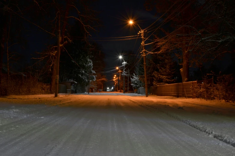 night time road that is covered in snow