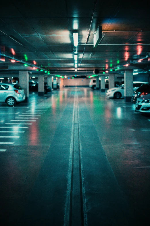 a very empty parking garage with green and red lights