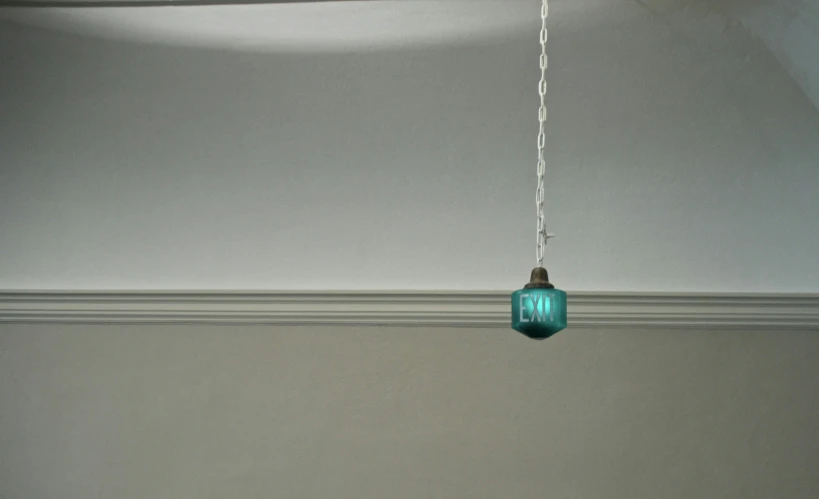 a light blue vase is hanging from a metal chain