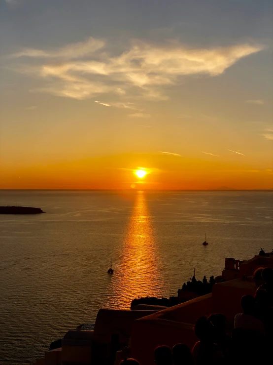 the sun is setting over the water at sea