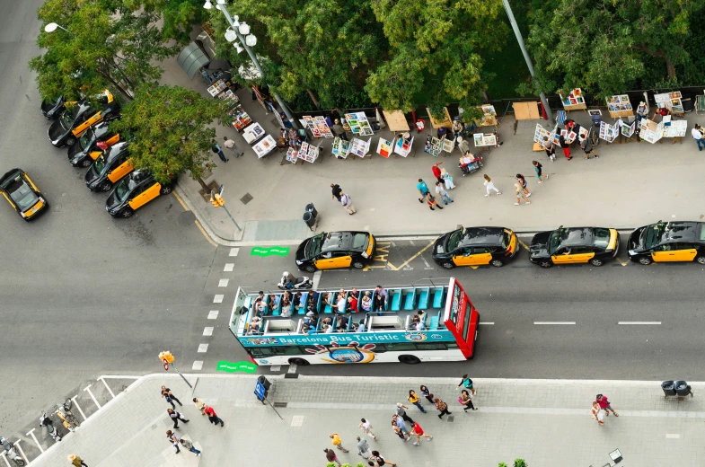 this aerial pograph shows people and buses in traffic