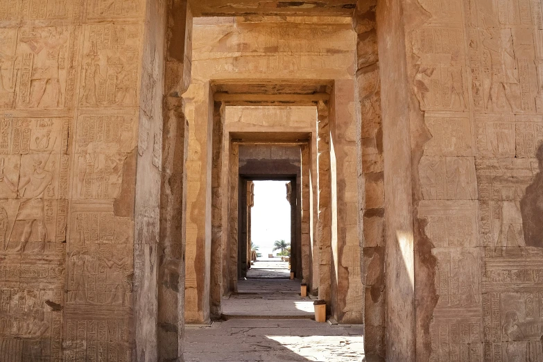 inside an egyptian style temple with lots of carvings