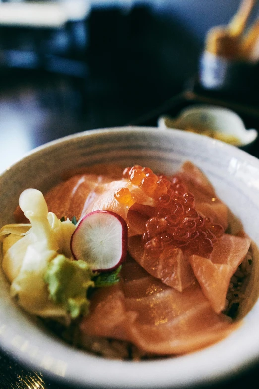 food dish displayed in white bowl on wood table