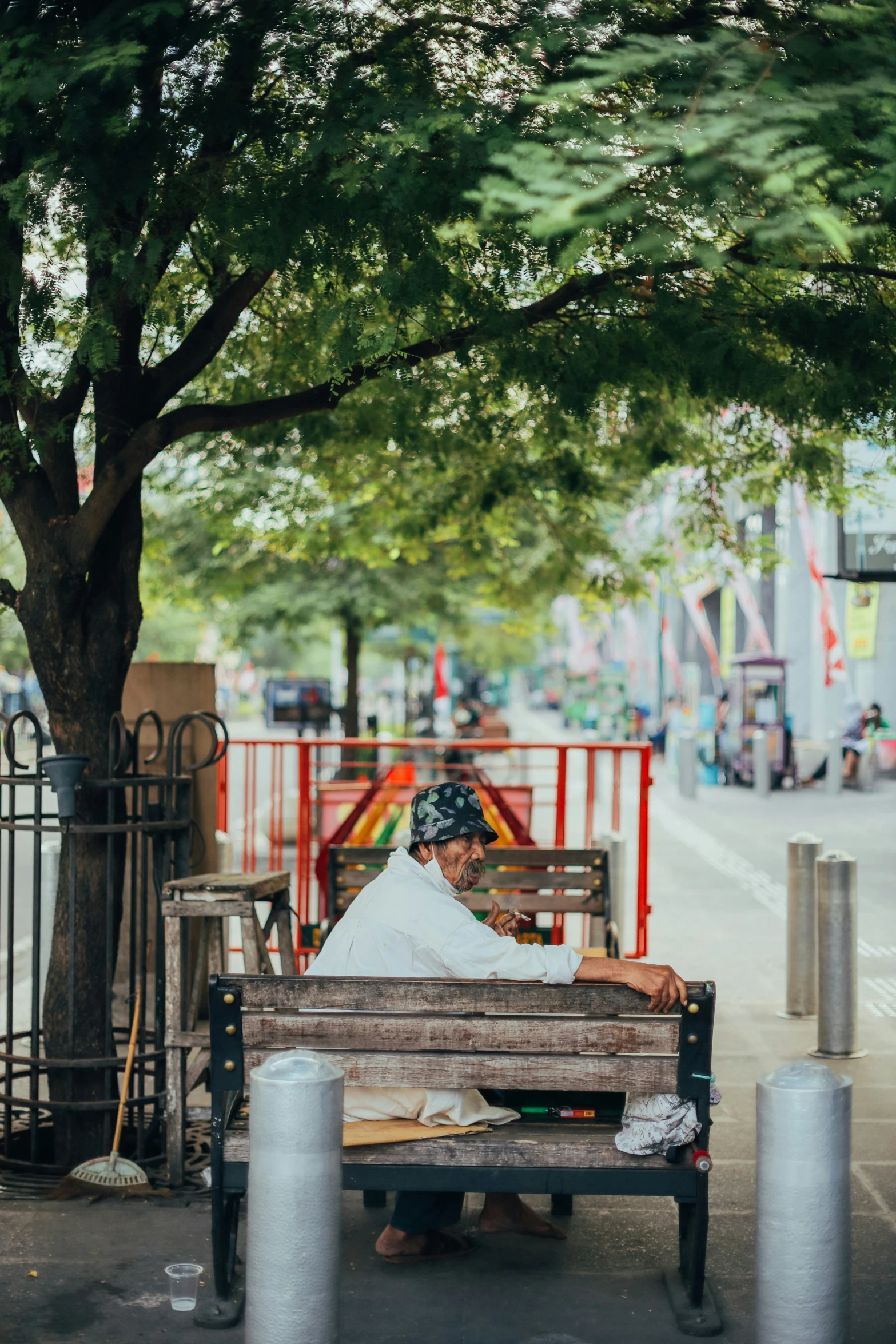 a man with a bandanna is sitting on a bench