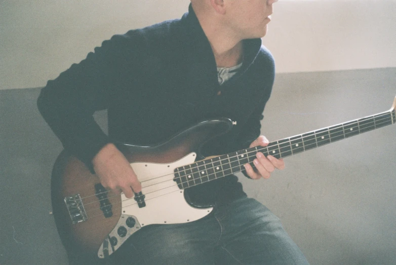 a man with an electric bass guitar