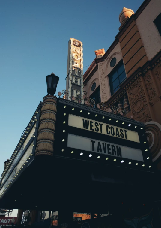 a building is lit up in the evening with lights and sign