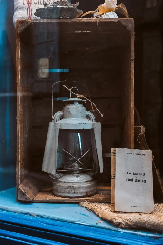 an old lantern on display with an interesting glass case