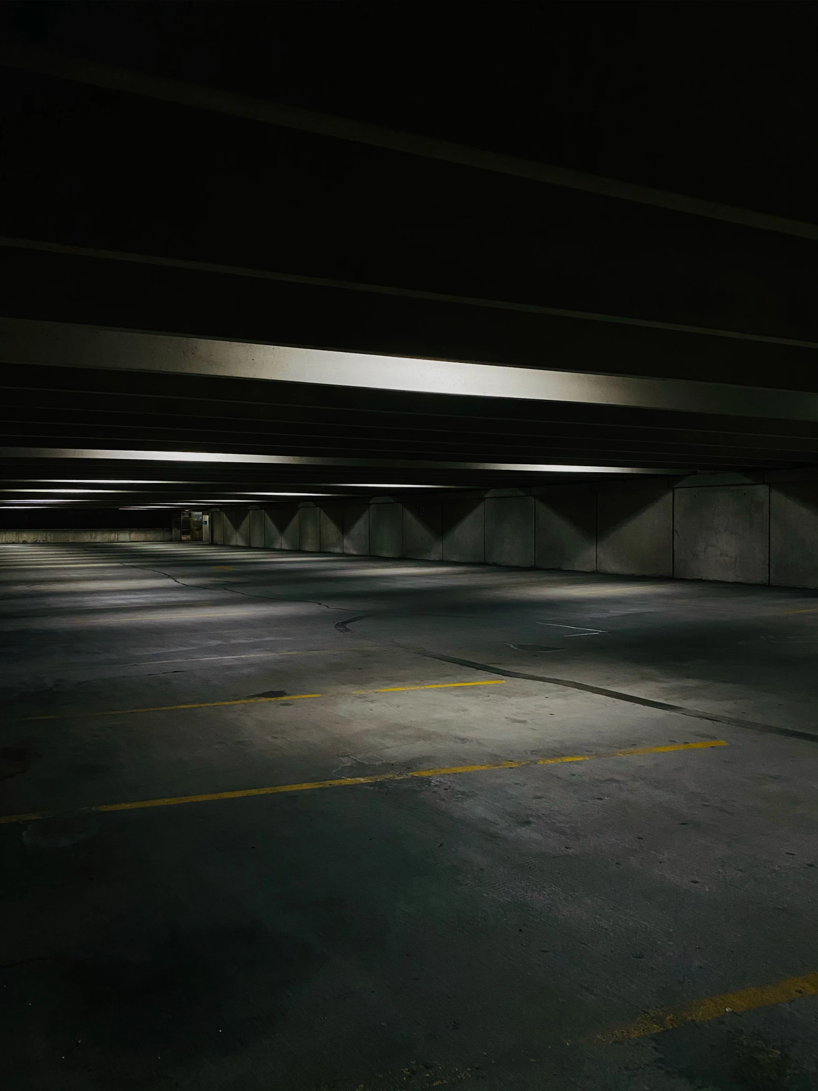 an empty car parking garage at night with parking lights