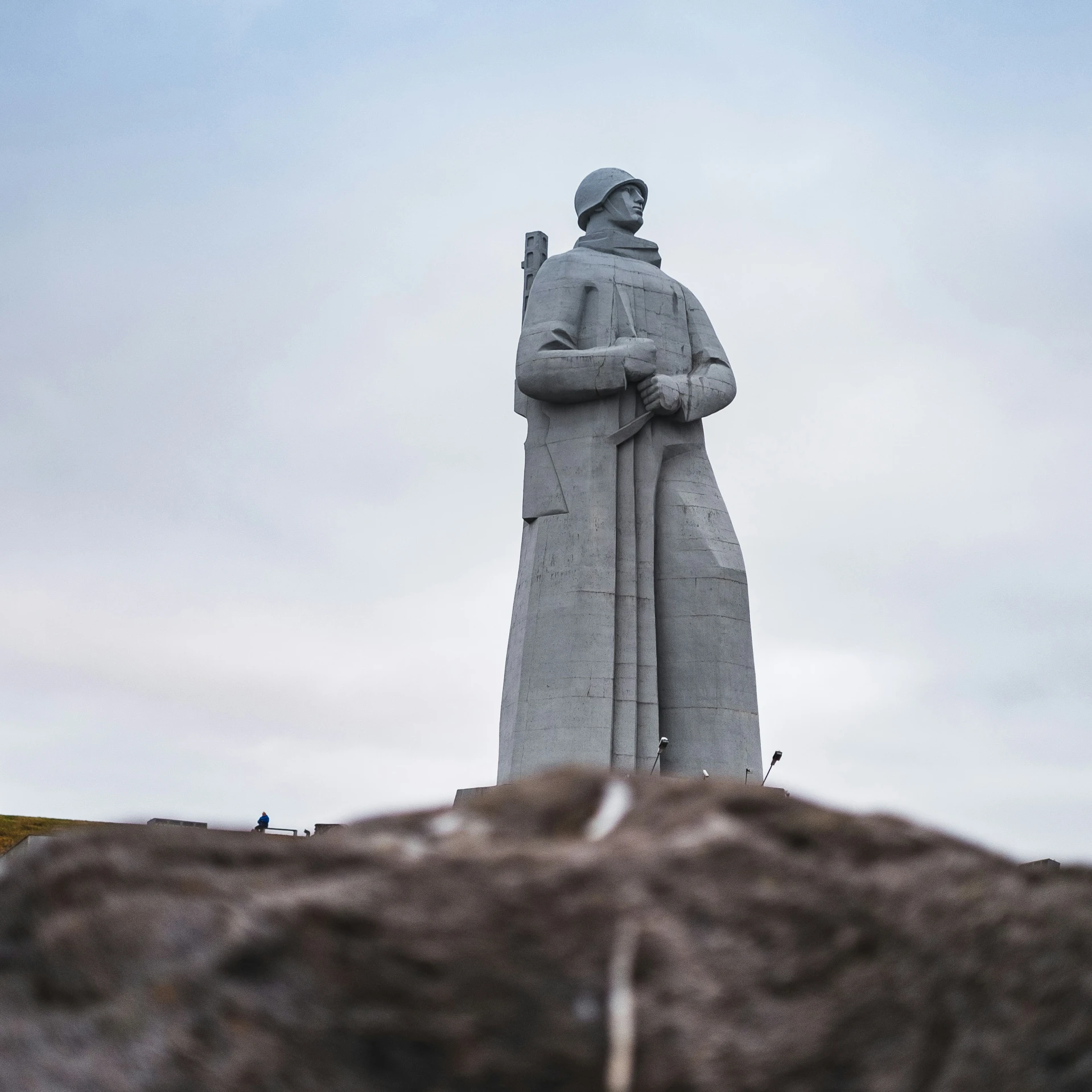 the monument is near rocks and is in a barren area