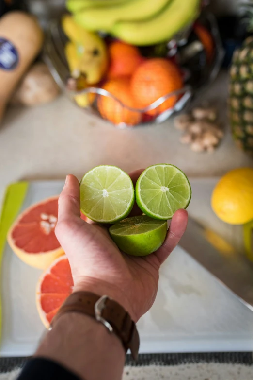 a person holding up a slice of fruit on a  board