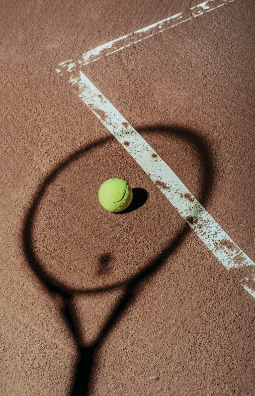 a tennis ball and racket on a tennis court