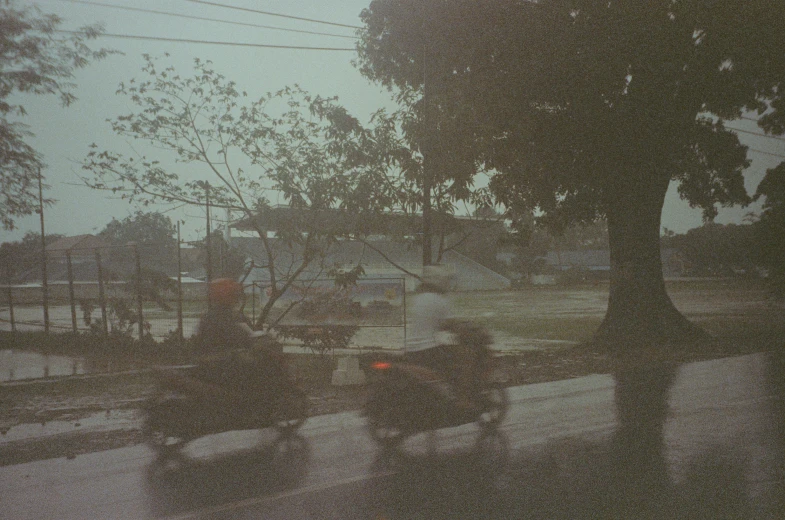 two people are riding bicycles while they drive in the dark