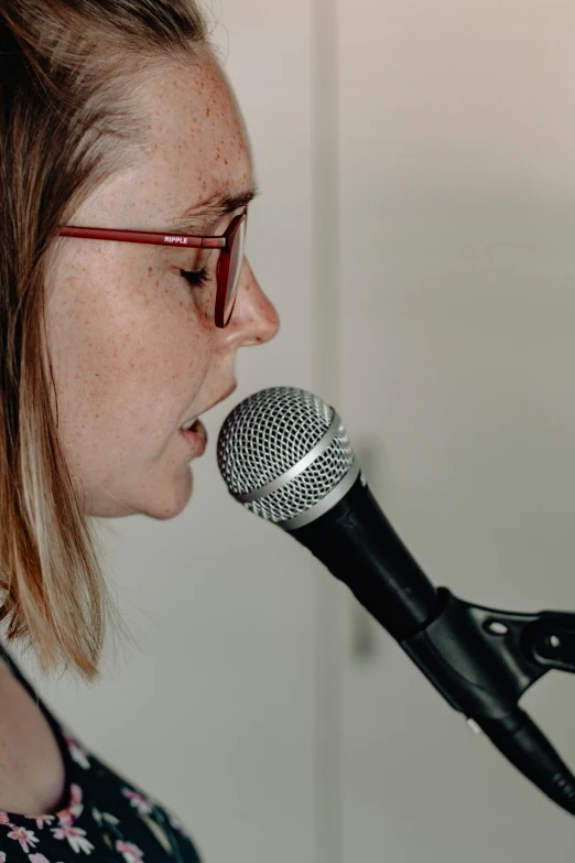 a woman is listening into a microphone and talking