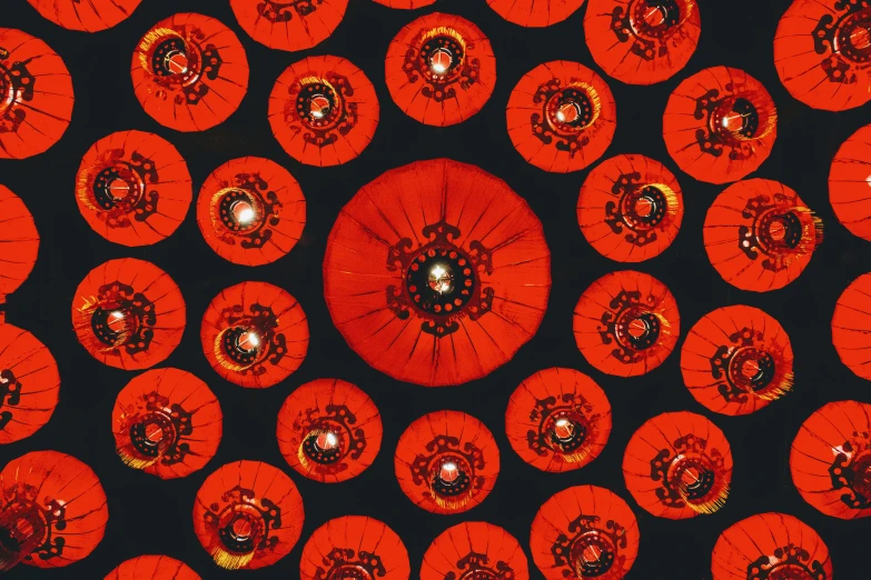 the red umbrellas are in a pattern against the black background