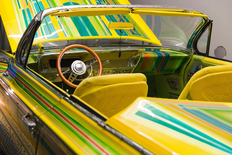 the interior of a car has colorful painted accents