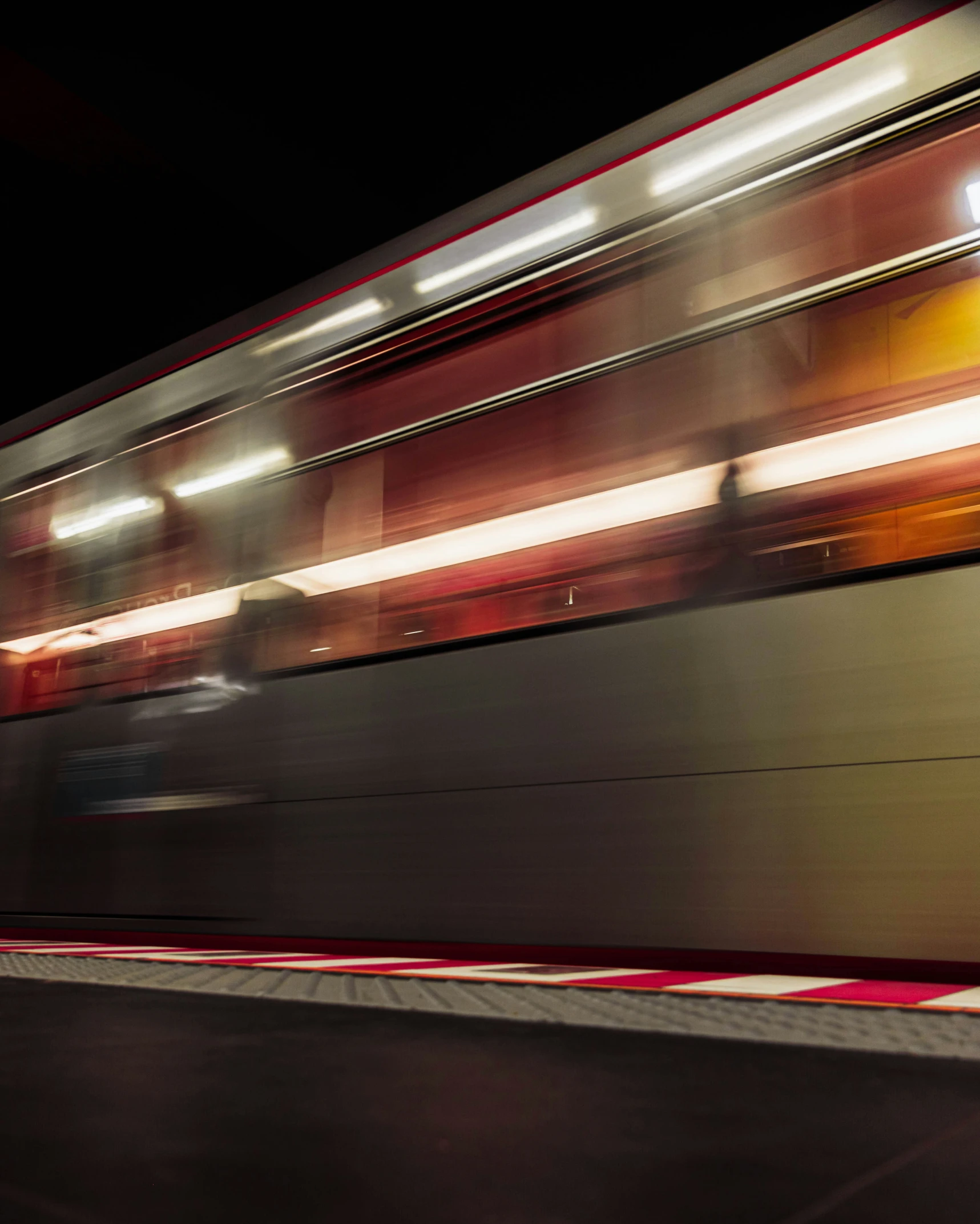 a passenger train moves in the dark with blurry light