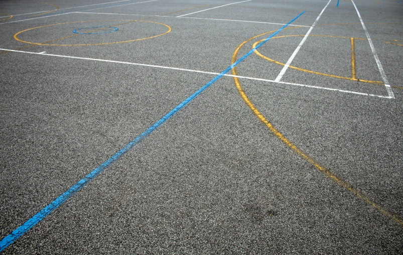 the painted lines in a parking lot indicate two sets of basketballs