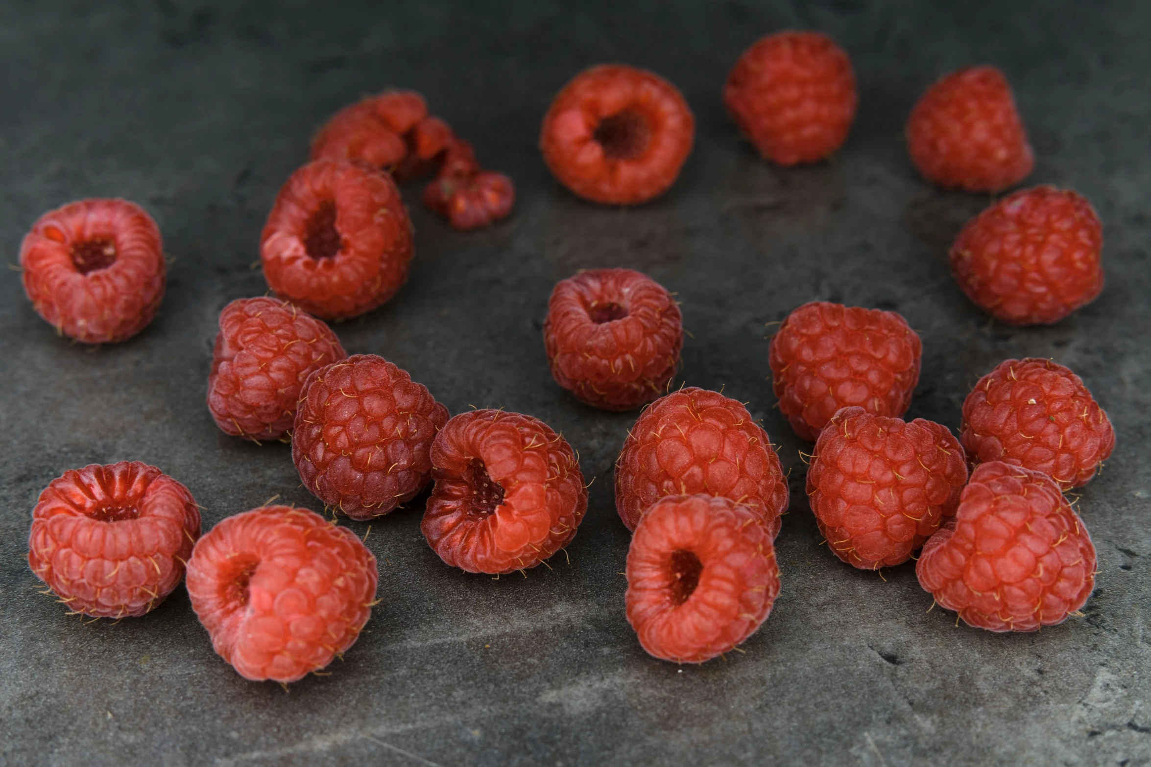 small raspberries lying on the counter top