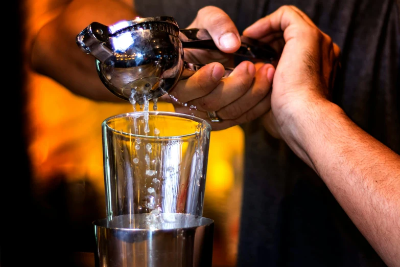 a person is filling a drink from a funnell