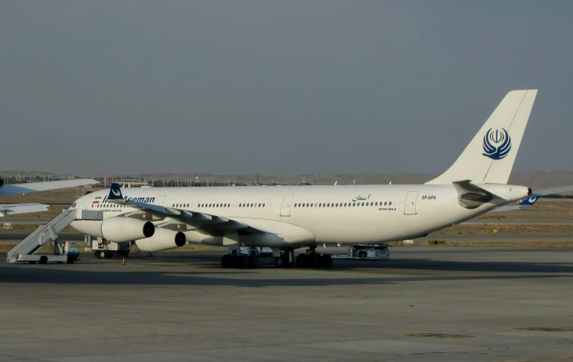 an airplane on the runway with another plane near it