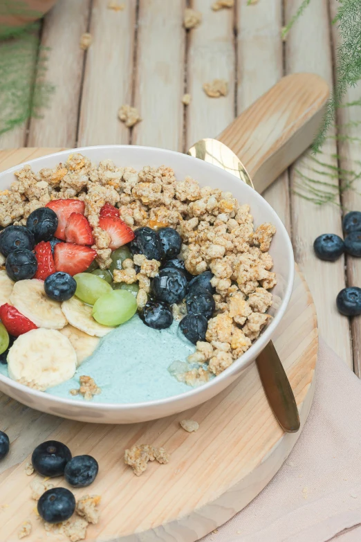 a bowl full of fruit with oats, strawberries, blueberries, and apple slices