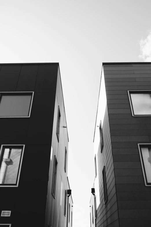 a city street with two tall black buildings