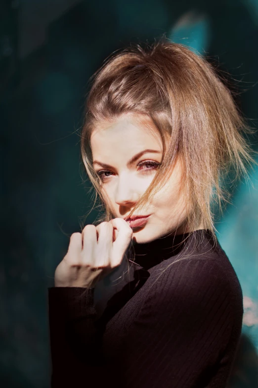 a woman in black blouse posing for the camera