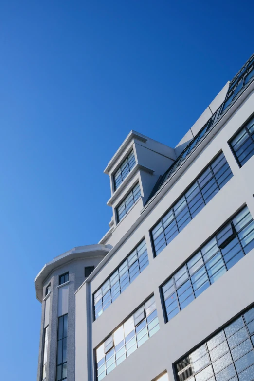 the exterior of a building with windows, and a bird perched on it