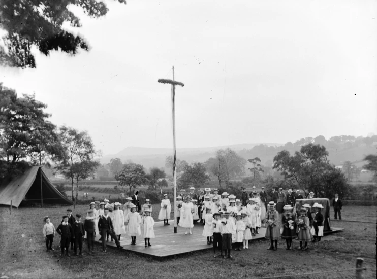 a group of people stand on a wooden platform