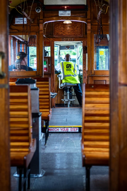 the inside of an empty train car with a driver