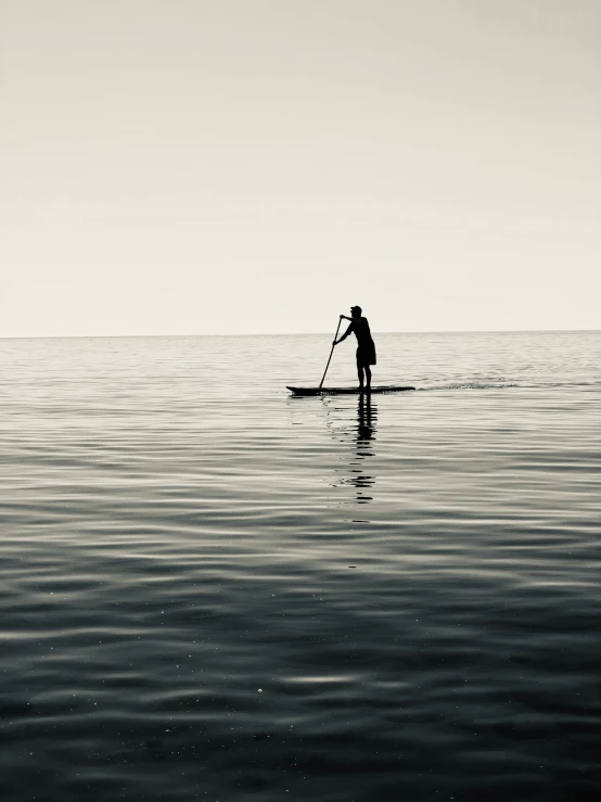 a person standing on a surfboard in the ocean