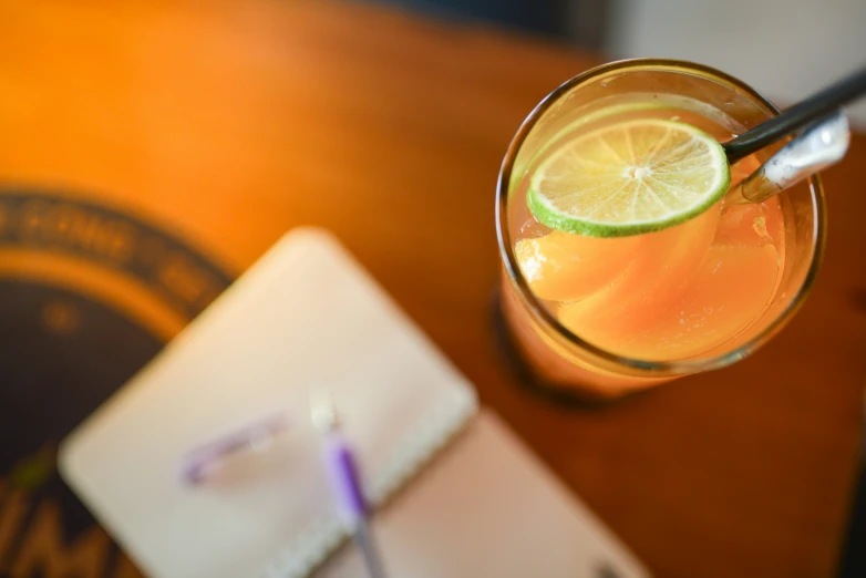 a glass with a straw sitting on a table