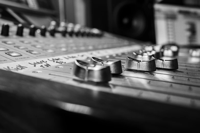 a close up of a sound mixing console in a recording studio