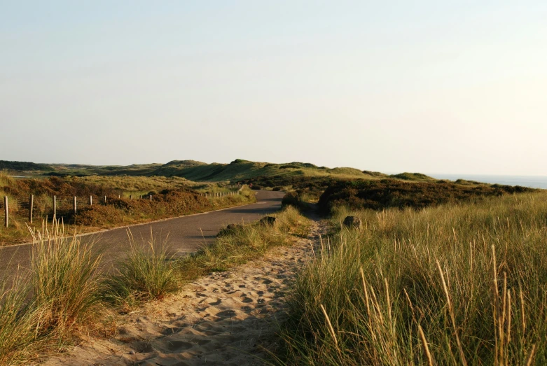 a view of a deserted road next to the ocean